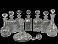 GROUP OF EIGHT CUT GLASS DECANTERS