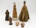 GROUP OF SIX WOOD SANTOS WITH CLOTHS
