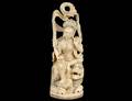 FINELY CARVED AND PARCEL GILT IVORY DEITY