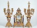 THREE PIECE BRASS AND PORCELAIN CLOCK GARNITURE