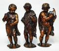 1285 SET OF THREE CARVED WOOD FIGURES OF PUTTI