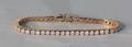 1196 GOLD AND DIAMOND TENNIS BRACELET