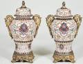 PAIR OF ENAMEL DECORATED PORCELAIN URNS AND COVERS