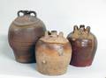1035 THREE PARTIAL GLAZED STONEWARE JUG