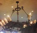 CHER IBERIAN STYLE PATINATED CAST IRON TEN LIGHT CHANDELIER