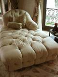 A LARGE SILK UPHOLSTERED CHAISE LOUNGE