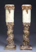 A PAIR OF BAROQUE STYLE CARVED AND GILDED CANDLEST
