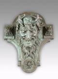 A CAST BRONZE DEVILS HEAD WALL MOUNT PLAQUE