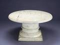 A ROUND PEDESTAL COFFEE TABLE