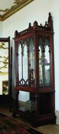 A GOTHIC STYLE WALNUT CABINET ON STAND