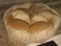 A VELVET UPHOLSTERED CIRCULAR POUFFE