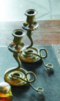 A PAIR OF SERPENT FORM CANDLESTICKS