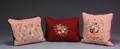 A GROUP OF THREE NEEDLEPOINT PILLOWS