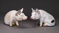 A PAIR OF VINTAGE PAINTED PLASTER PIGS