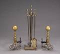 A SET OF BRASS ANDIRONS AND FIREPLACE TOOLS