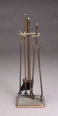 A SET OF HAMMERED IRON FIREPLACE TOOLS