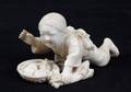A VINTAGE FIGURAL JAPANESE NETSUKE OF A BOY WITH F
