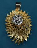 111 EIGHTEEN KARAT GOLD AND DIAMOND FLOWER BROOCH