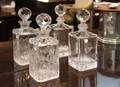 GROUP OF COMMEMORATIVE CUT GLASS DECANTERS WITH STOPPERS