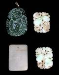485 GROUP OF FOUR CARVED JADE PENDANTS