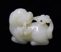 260 CARVED WHITE JADE FIGURE OF A FU DOG