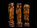 517 GROUP OF THREE CARVED AND STAINED IVORY FIGURES