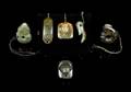 A Group of Six Spinach Jade Pendants