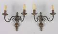 A Pair of Patinated Metal Dutch Style TwoLight Sconces