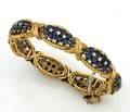 A Ladys Yellow Gold Blue Sapphire and Diamond Bracelet