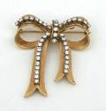A Ladys Yellow Gold and Diamond Bow Pin