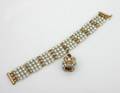 A Ladys Four Strand 14 Karat Yellow Gold and Cultured Pearl Bracelet