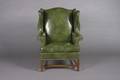 A Green Leather Upholstered Wingback Armchair