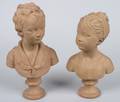 A Pair of Cast Terra Cotta Busts of Children