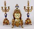 A Louis XVI Style Three Piece Clock Garniture Set