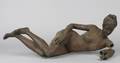 A Cast Metal Reclining Figure of a Nude Female