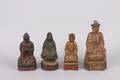 A Group of Four Asian Red Lacquer and Gilt Carved Wood Temple Figures