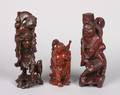 A Group of Three Chinese Carved Wood Figures of Hotei