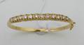 A Ladys 18 Karat Yellow Gold and Diamond Hinged Bangle Bracelet