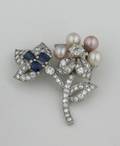 A Ladys Platinum Diamond Cultured Pearl and Synthetic Sapphire Brooch