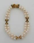 A Ladys 18 Karat Yellow Gold and Cultured Pearl Double Strand Bracelet MIKIMOTO