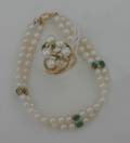 A Ladys Yellow Gold Double Strand Cultured Pearl Emerald and Diamond Bracelet