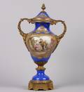 A Sevres Style Gilt Mounted Porcelain Covered Urn