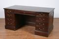 A Double Pedestal Mahogany and Burl Walnut Desk