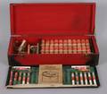 An AC Gilbert Chemistry Set in Red Wooden Box