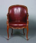 A Louis XV Style Walnut and LeatherUpholstered Bergere