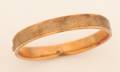 A Ladys 14 Karat Yellow Gold Hinged Bangle Bracelet