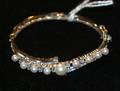 A Ladys 14 Karat White Gold Diamond and Cultured Pearl Hinged Bangle Bracelet