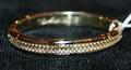 A Ladys 14 Karat Yellow Gold Hinged Bangle Bracelet