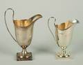 A Group of Two English Silver Helmet Form Creamers