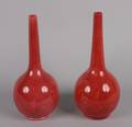 A Pair of Red Ceramic Bottle Form Vases